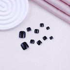 Black and white polka dot toenails