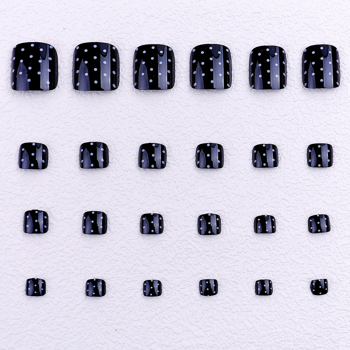 Black and white polka dot toenails