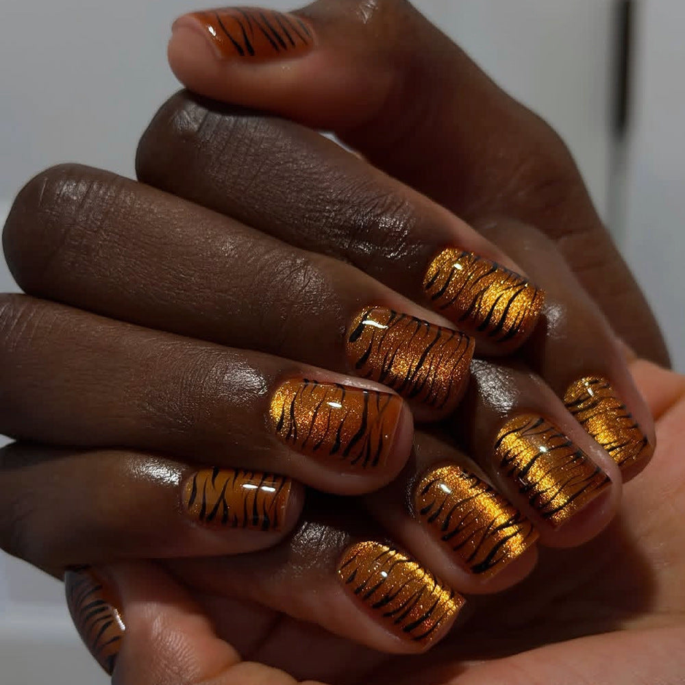 Metallic orange tiger-striped nails
