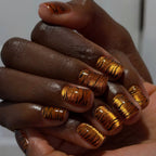 Metallic orange tiger-striped nails