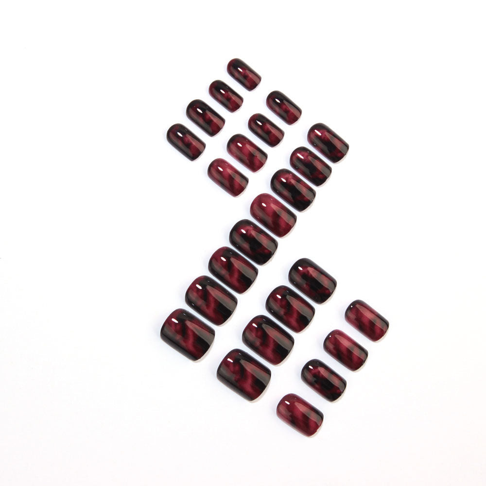 Wine red smudges the nails
