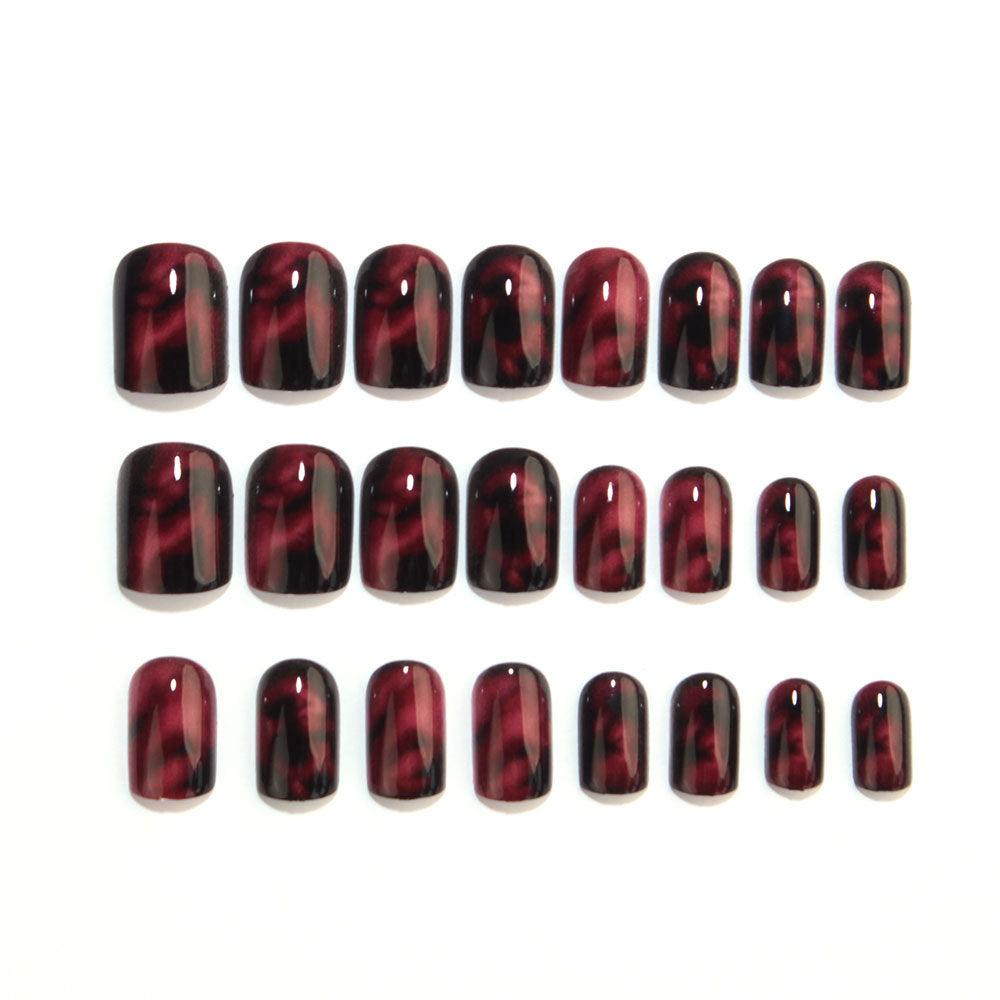 Wine red smudges the nails