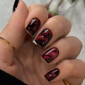 Wine red smudges the nails