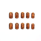 Metallic orange tiger-striped nails