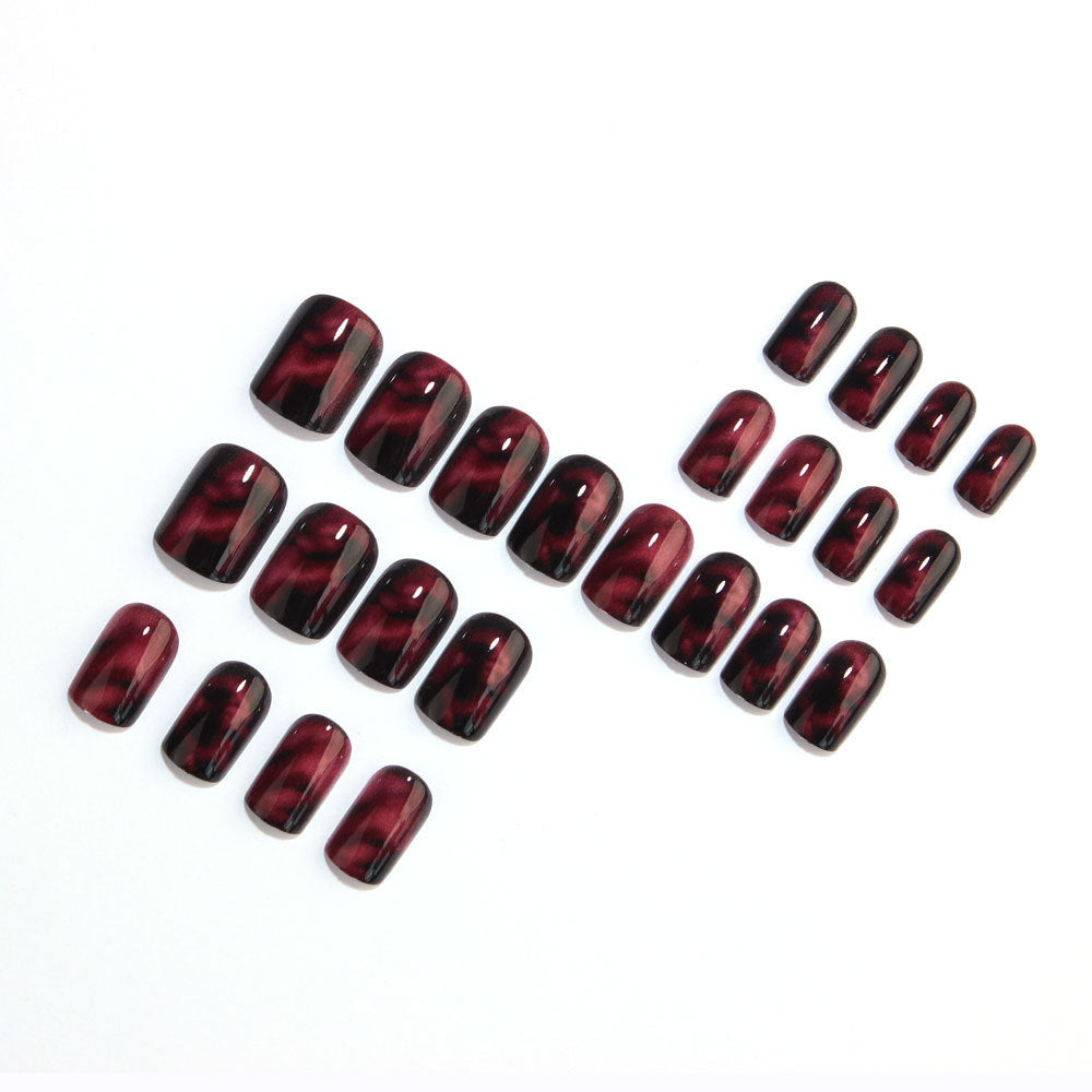 Wine red smudges the nails