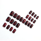 Wine red smudges the nails